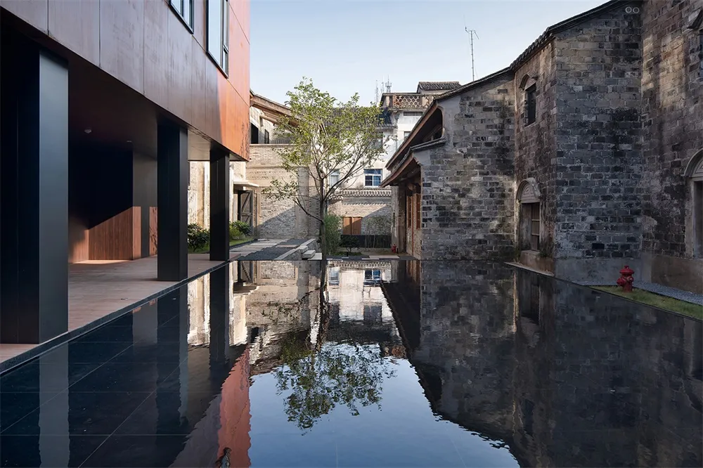 Modern building exterior with metal cladding and concrete stone elements