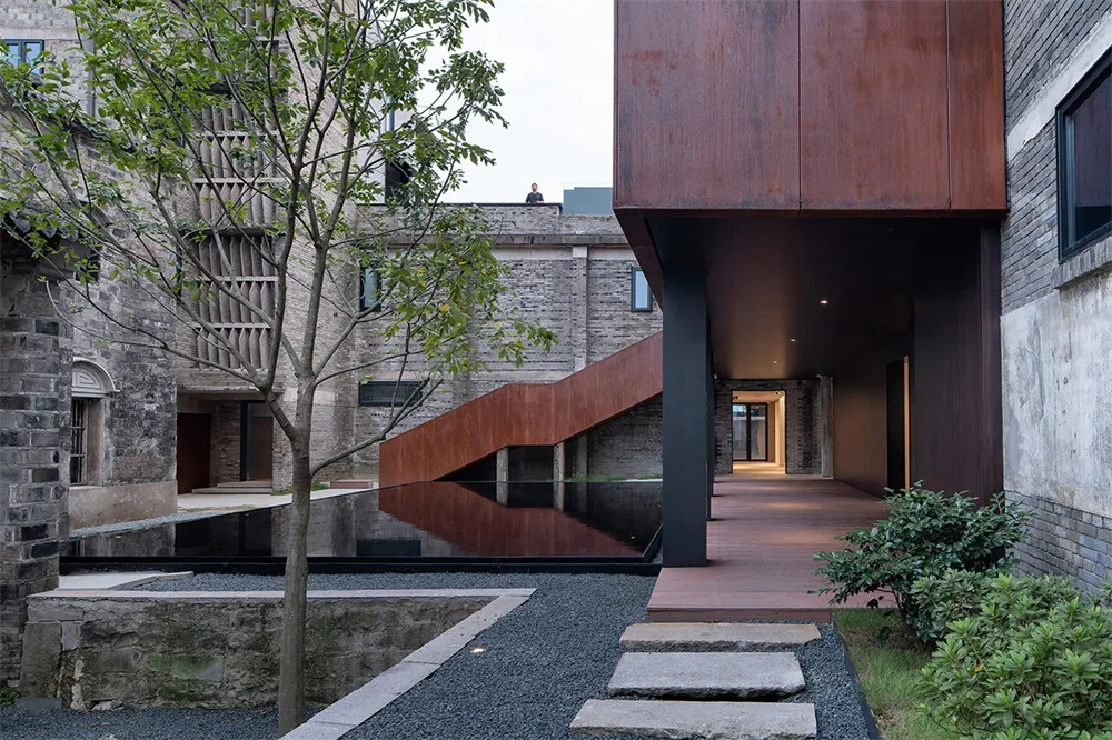 A modern interior design featuring a mix of wood, metal, and glass materials.