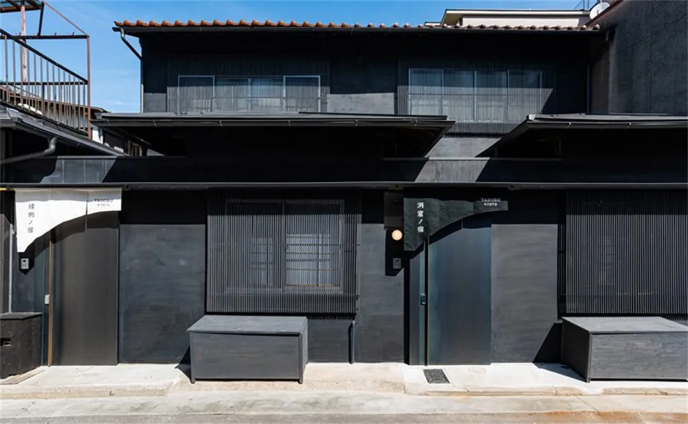 A modern retail storefront with concrete, metal, and wooden elements.