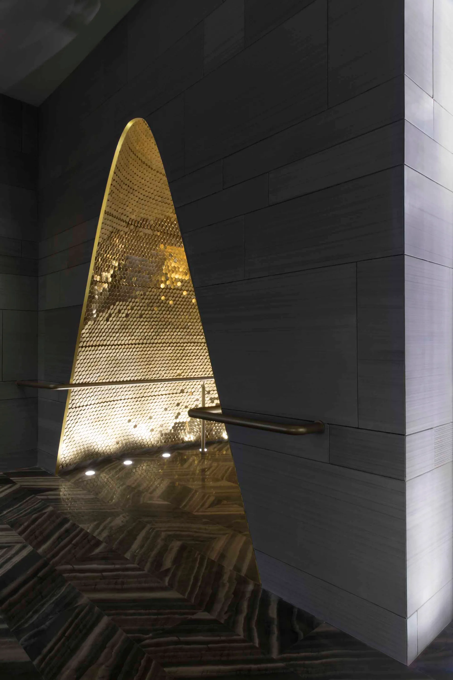 A sleek, modern interior design featuring metallic tiles and concrete