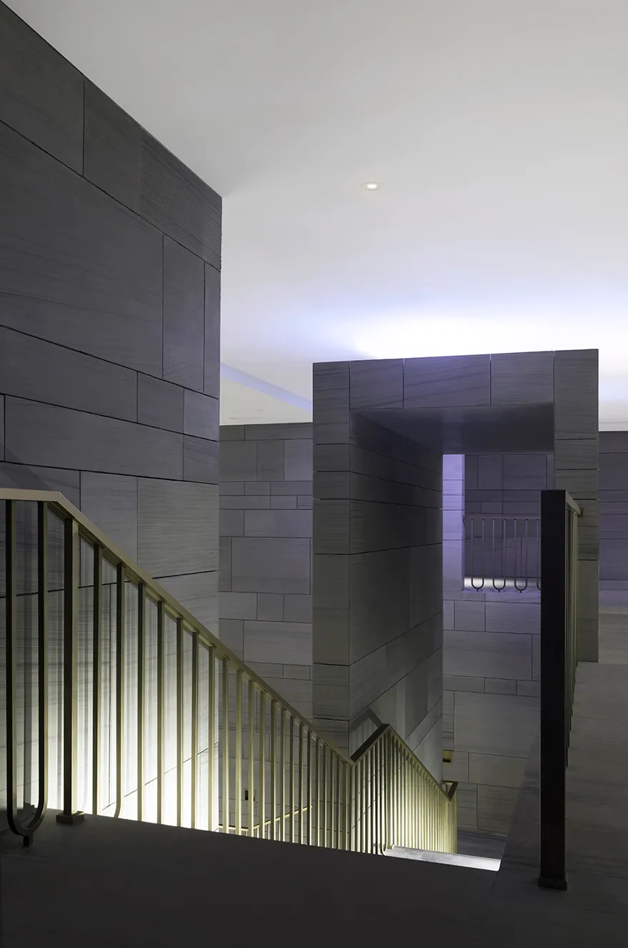 Image of a modern industrial luxury residential interior with stone and concrete materials.