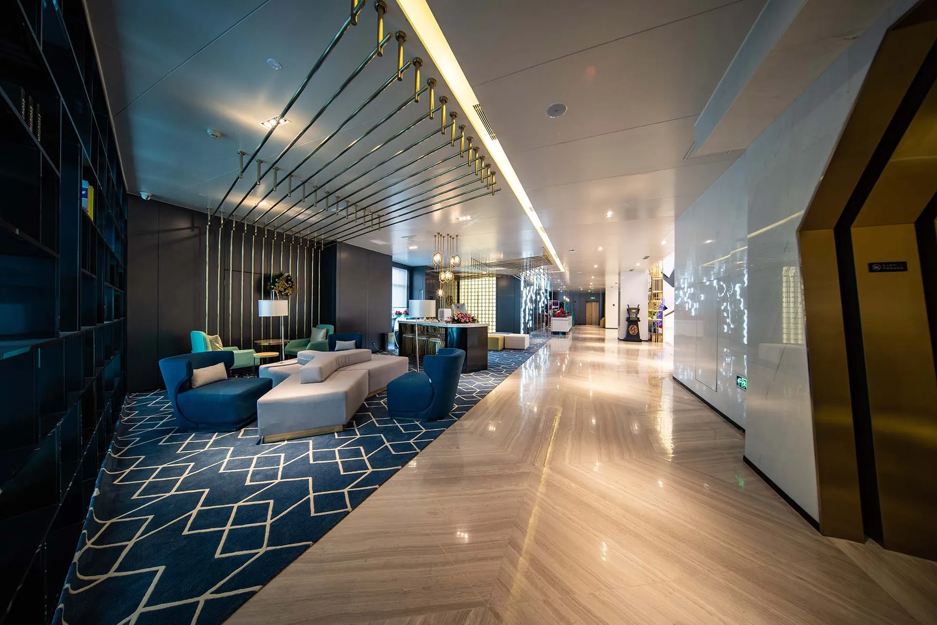 A modern hotel lobby featuring marble and concrete materials.