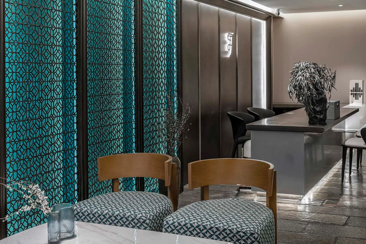Modern, minimalist restaurant interior with metallic glass panel walls
