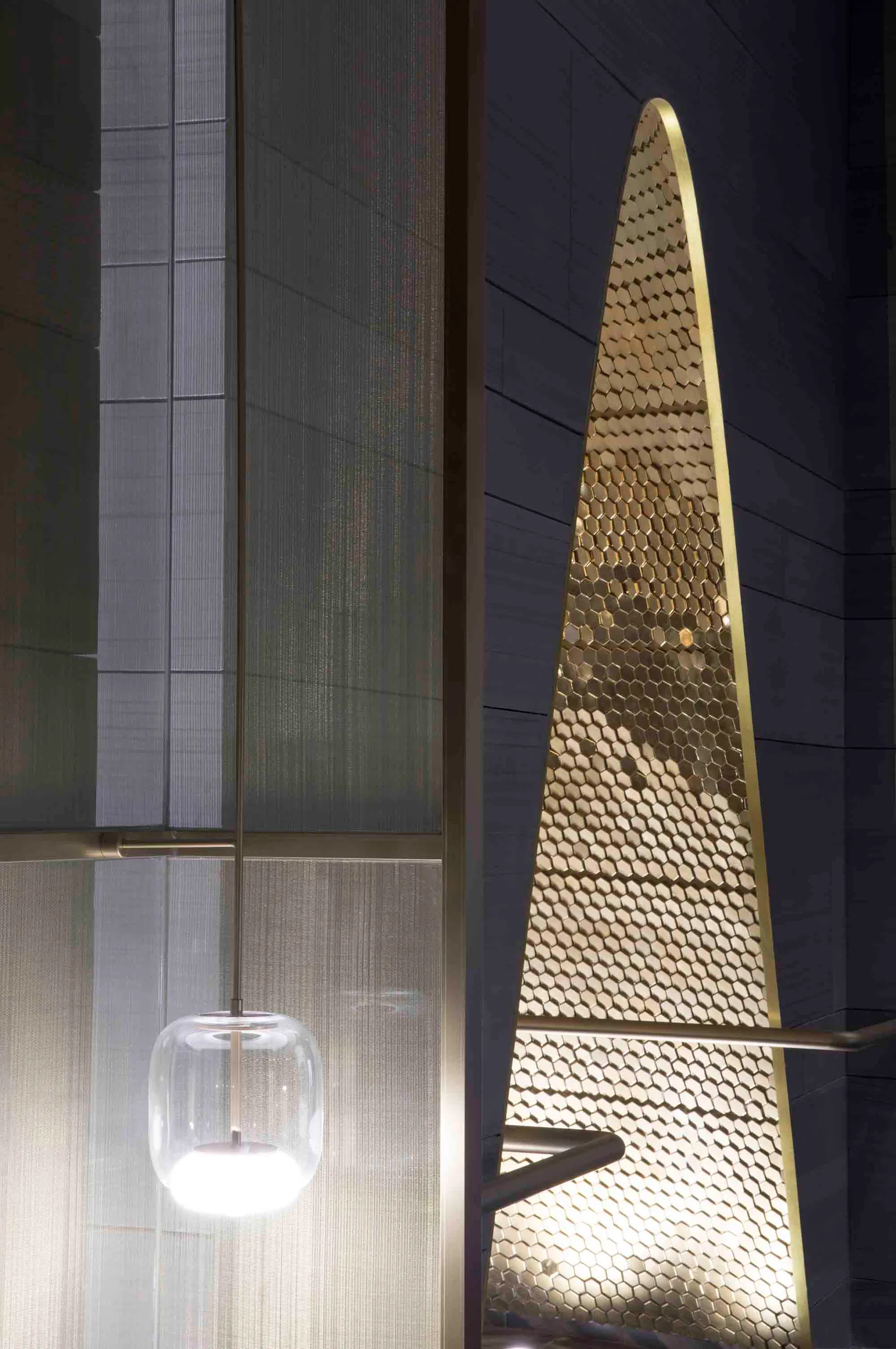 A modern staircase design featuring metallic mesh material.