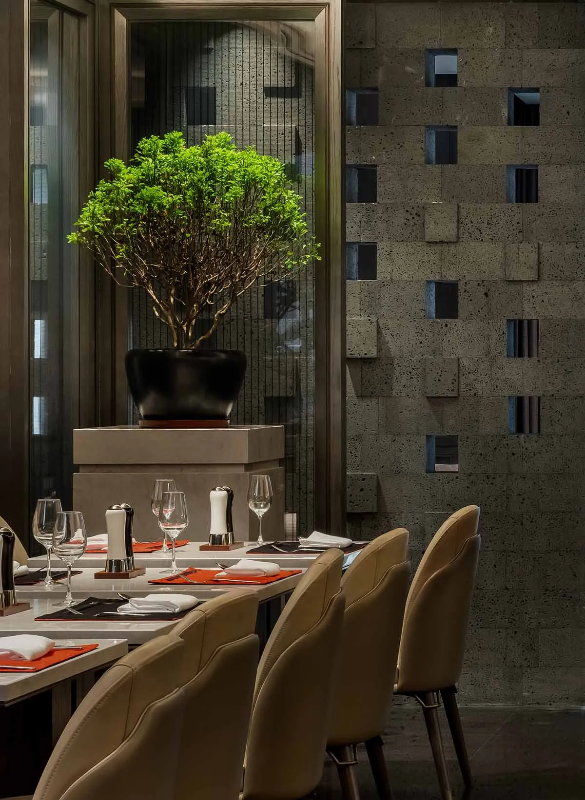 Modern dining room with concrete walls and minimalist furniture.