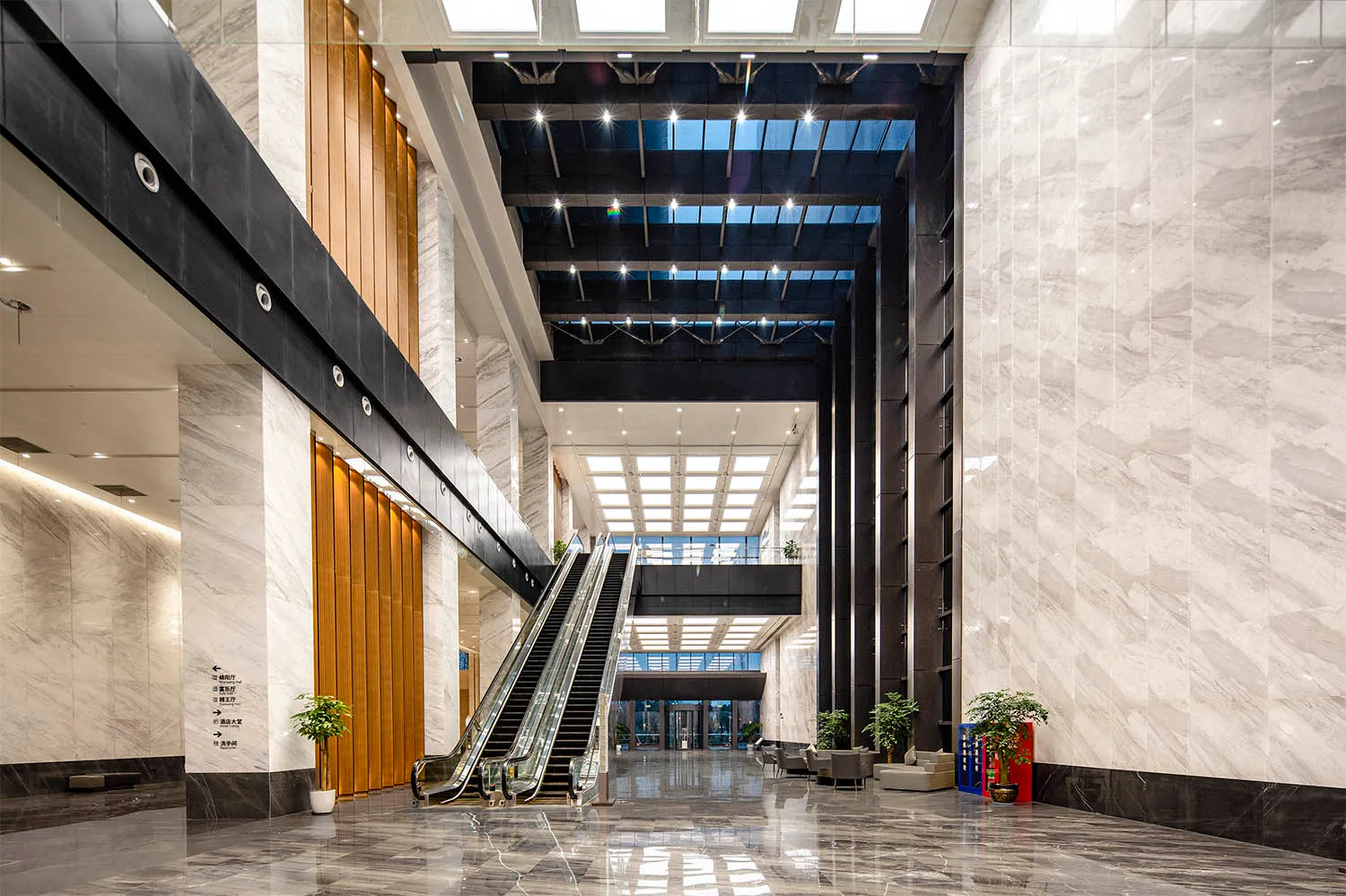 Modern lobby featuring marble walls and concrete floors.