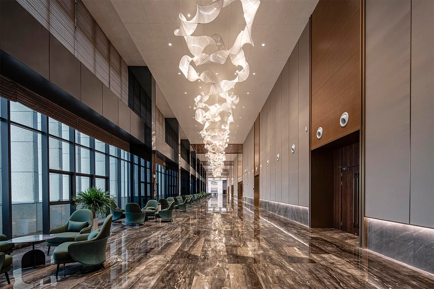 Modern interior design featuring a marble hallway with sleek, contemporary seating and lighting fixtures.