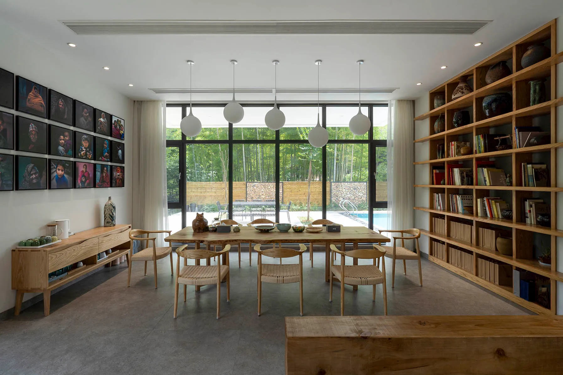 A modern living room with wooden furnishings and a large window.