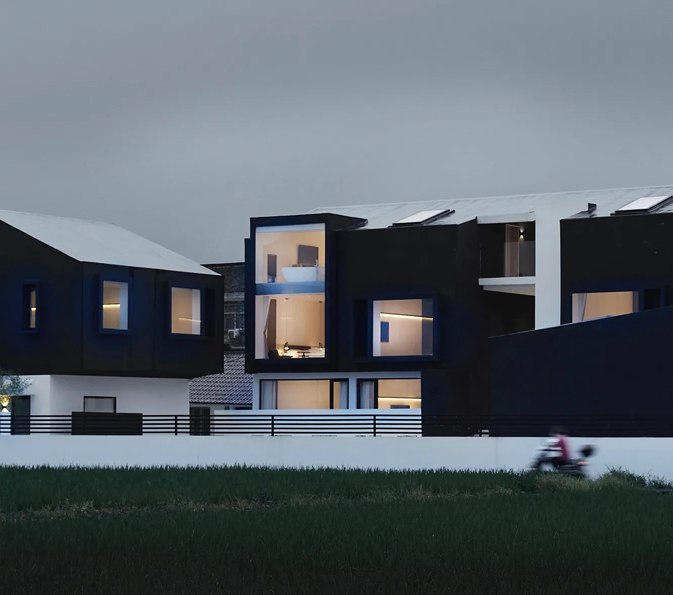 A modern house exterior with concrete walls and a white roof.