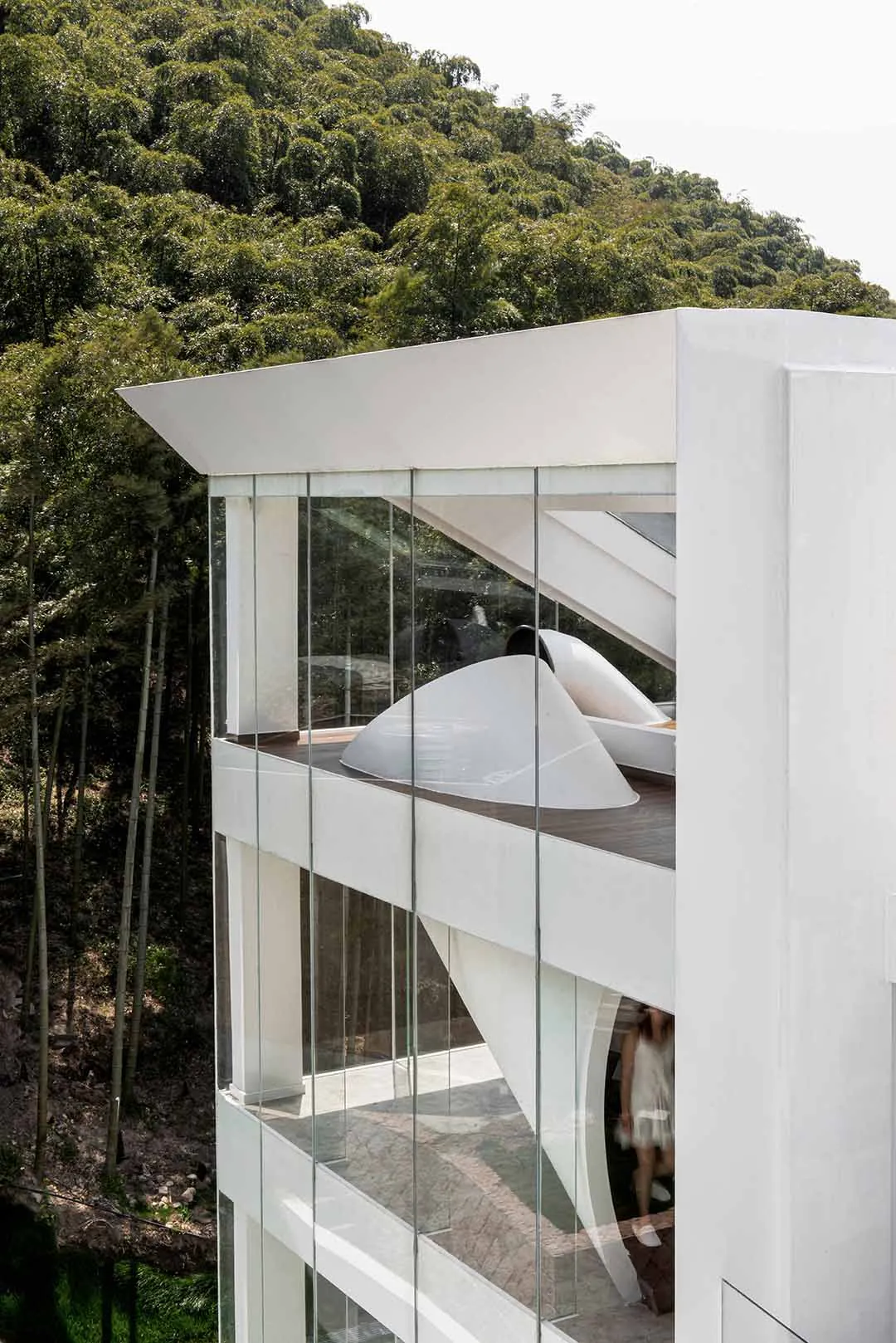 Modern residential building with glass and concrete exterior.