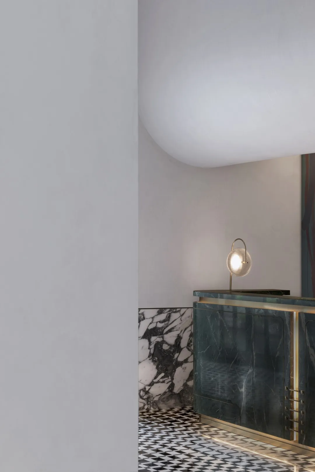 A modern living room featuring a mix of dark and light stone materials.