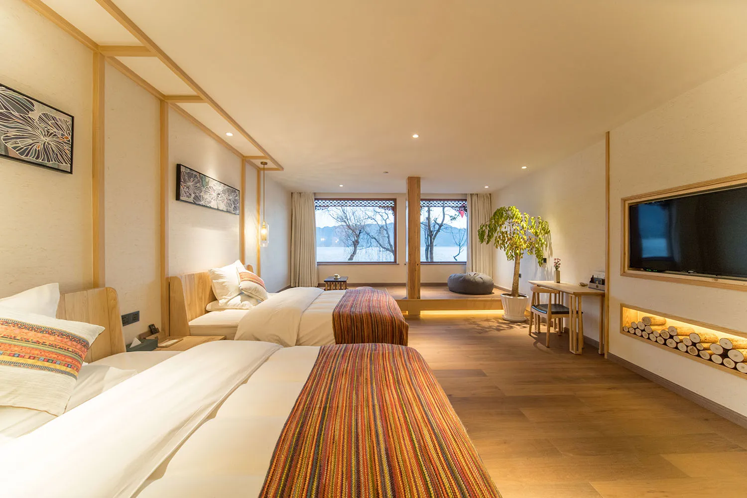 Modern bedroom suite with white bed, glass door, and wooden accents.