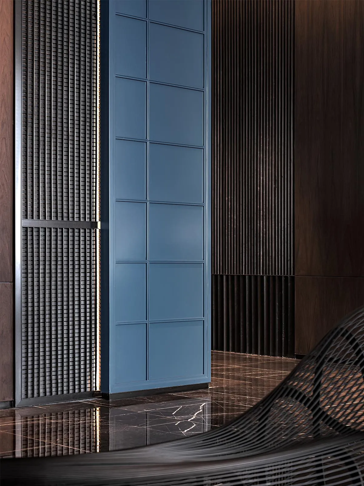Modern lobby featuring metal and wood materials.