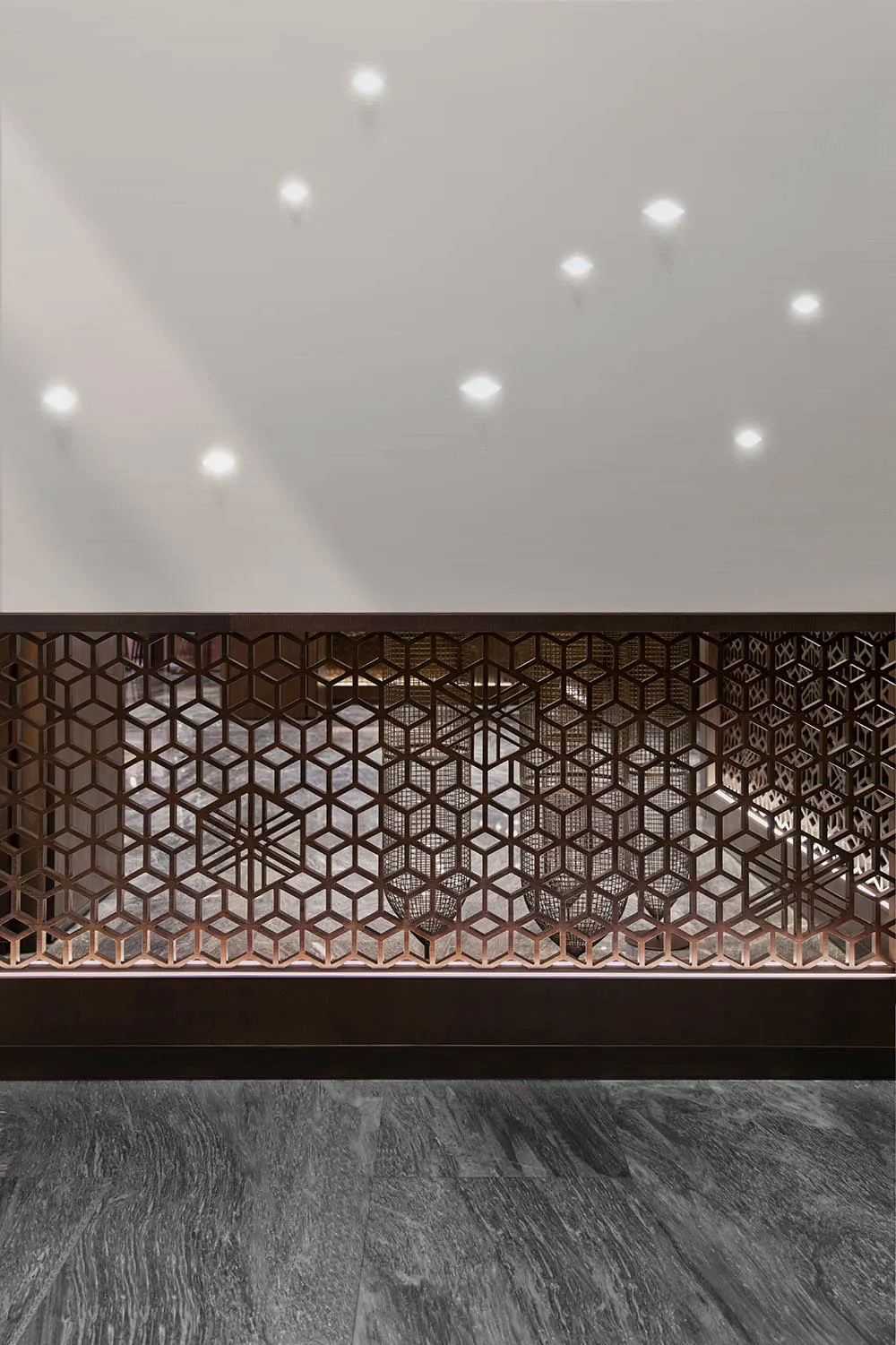 A modern commercial lobby featuring metallic geometric screens