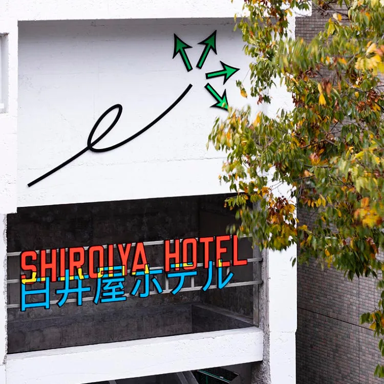 Modern hotel entrance featuring sign with metal frame and neon lights