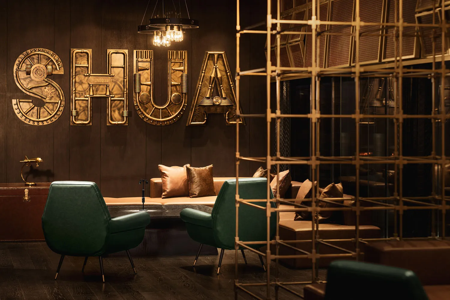 A modern industrial-style lobby featuring metallic decor and seating arrangements with leather accents.