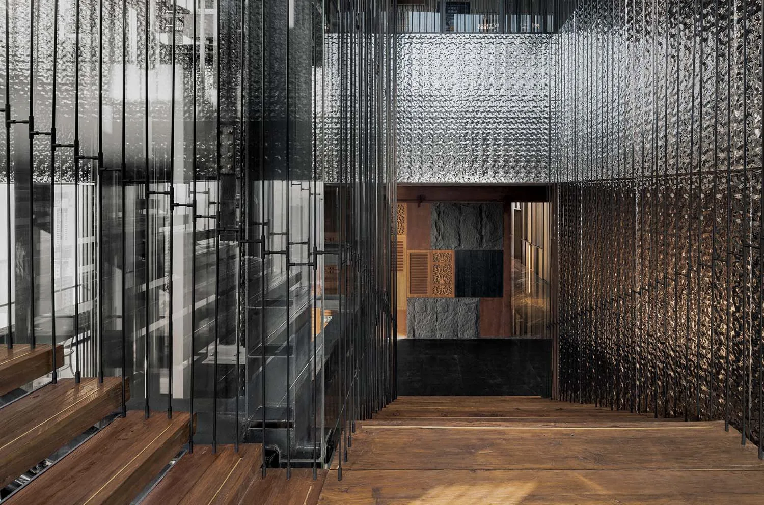 Modern industrial commercial interior with metal, glass, and concrete materials.