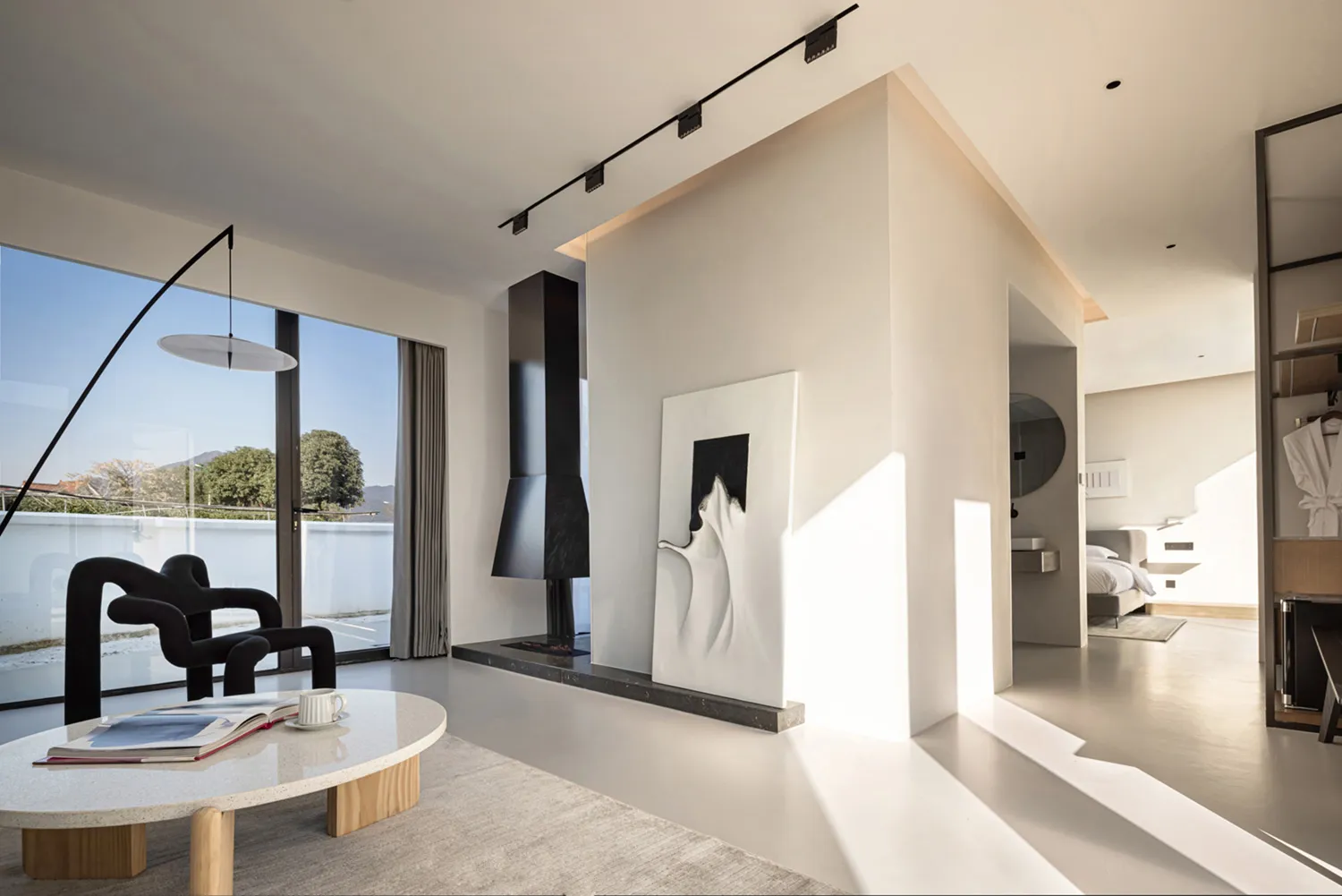 Modern living room with concrete elements and minimalistic design.