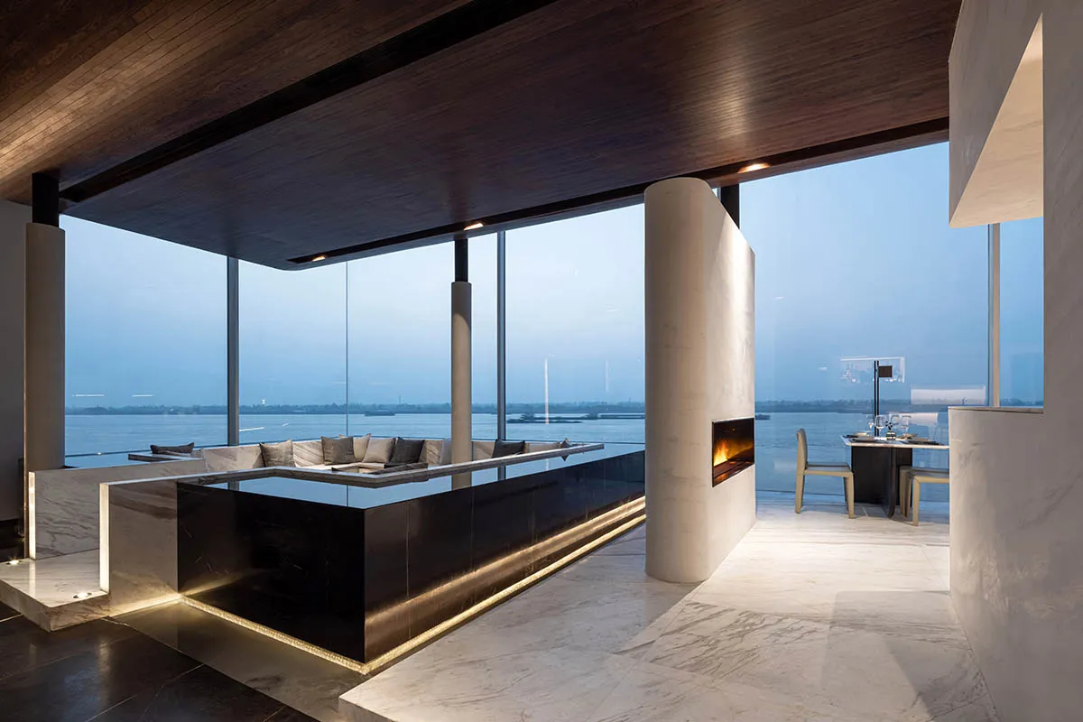 Modern living space with glass walls overlooking the sea