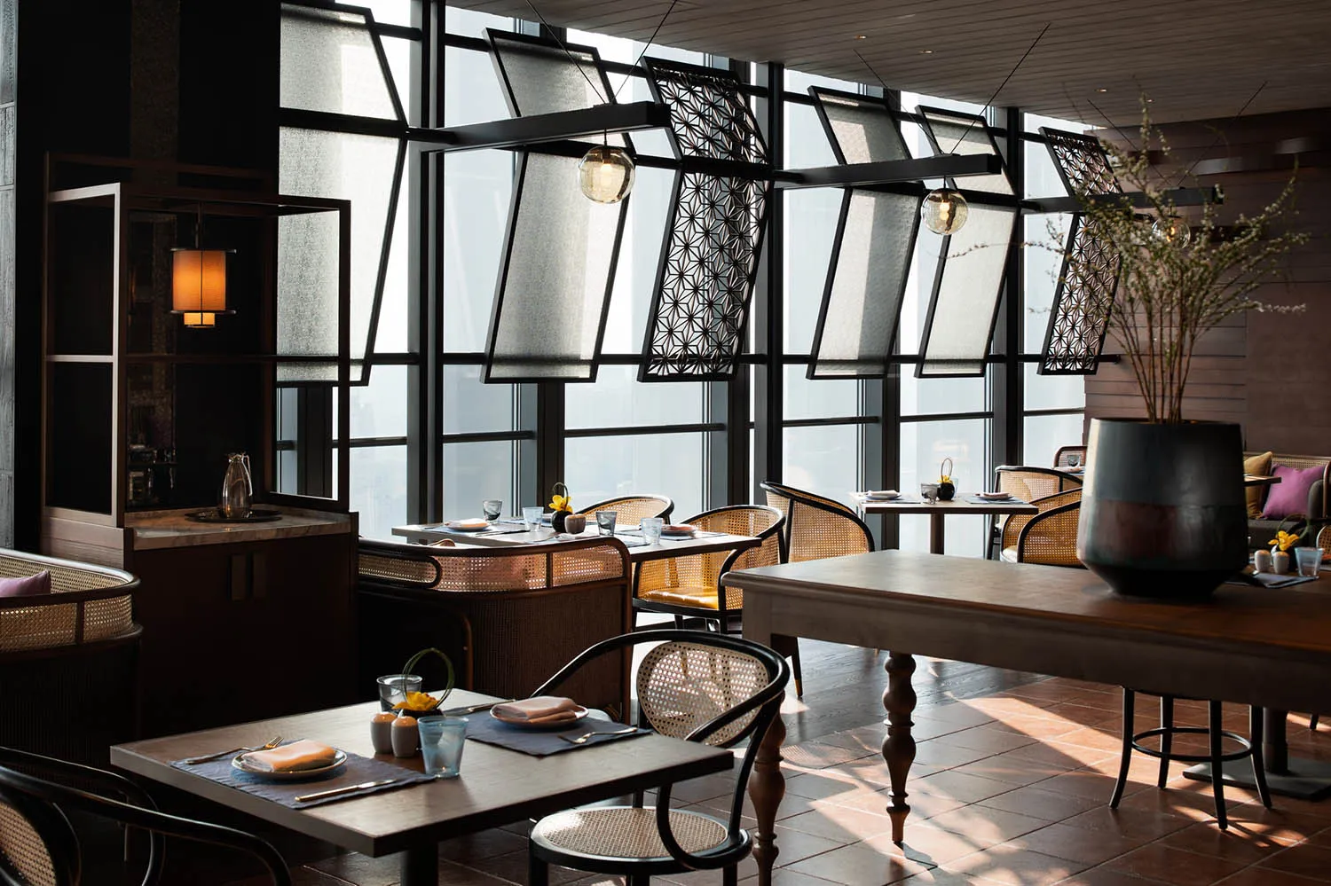 A modern restaurant interior with wooden furnishings and decorative elements.