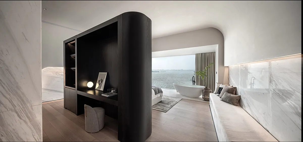 A modern minimalist bedroom featuring marble and wood materials.