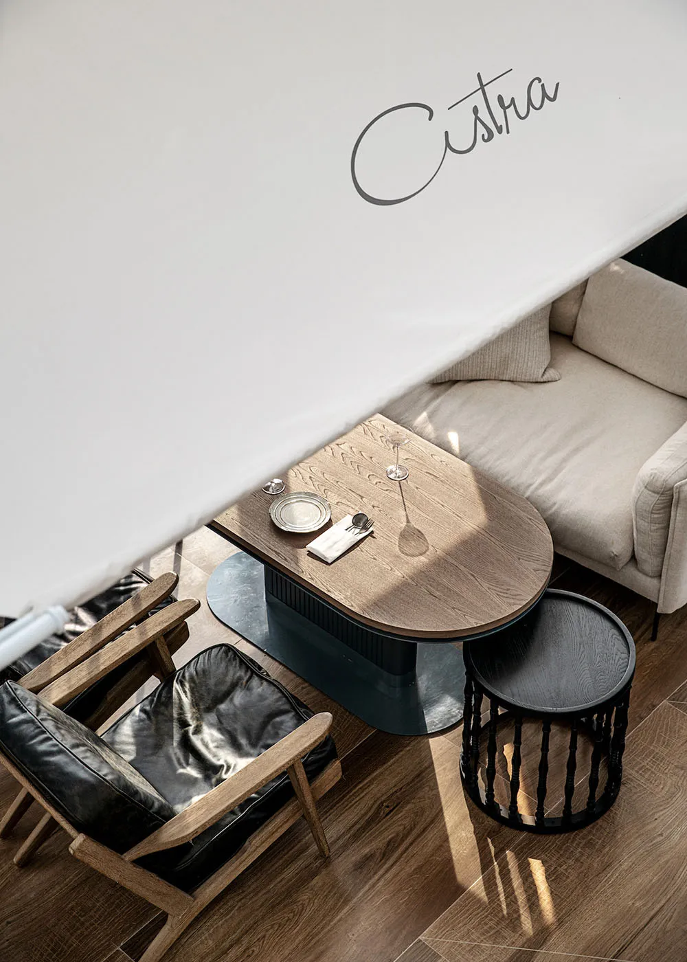 A cozy coffee shop featuring a modern design with wooden furniture and minimalist decor.
