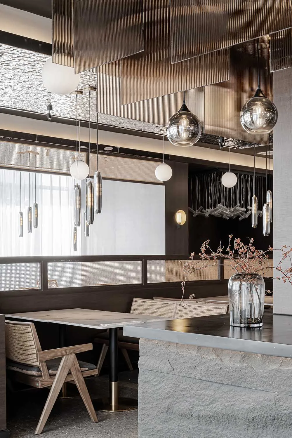 Modern restaurant interior with concrete and glass materials.