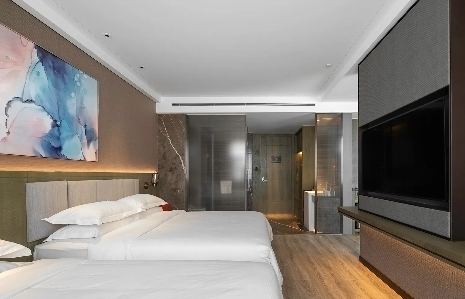 Modern bedroom suite featuring marble and wood elements.