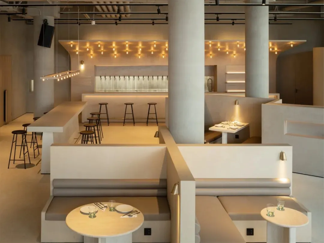 Modern restaurant interior featuring concrete and wood materials