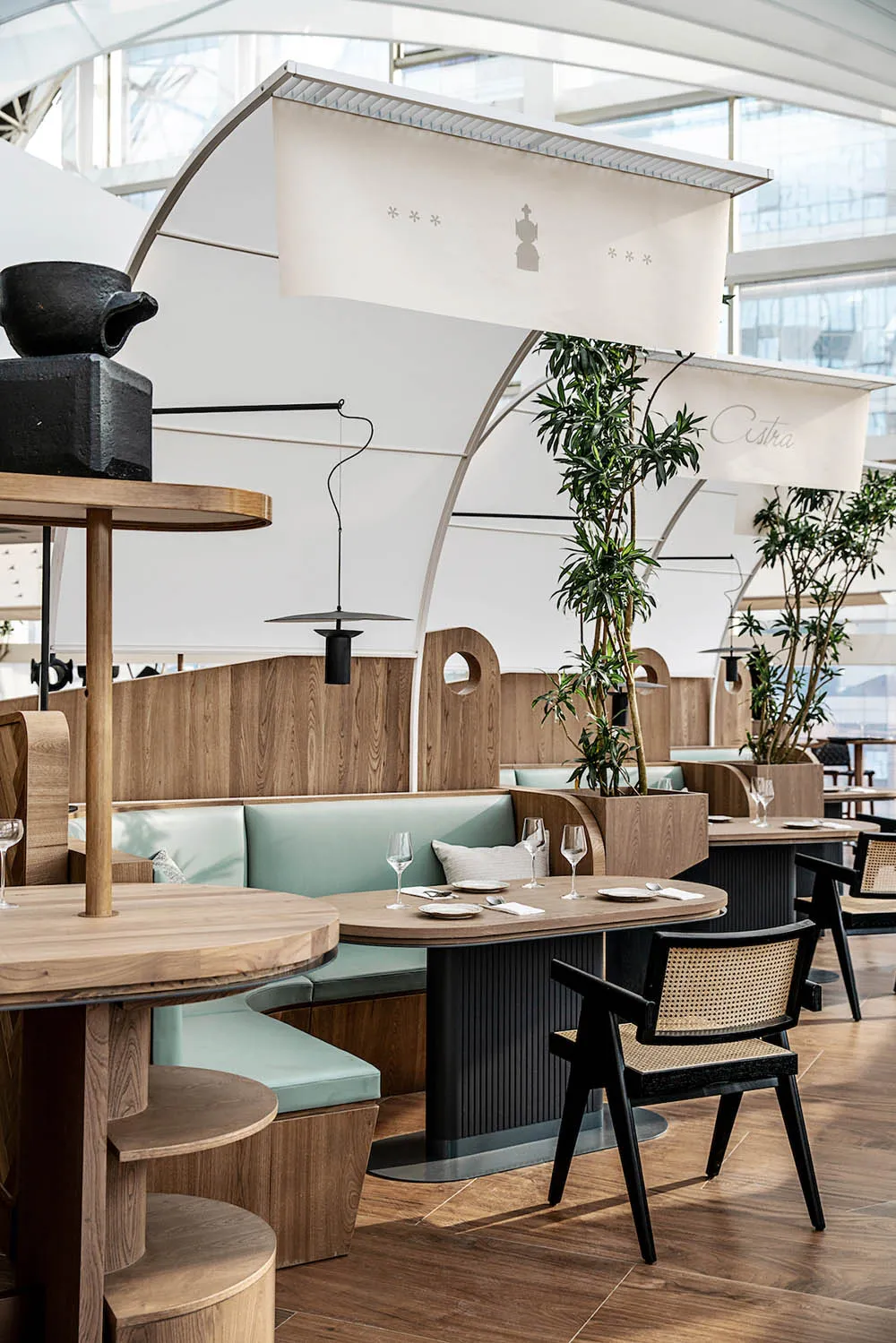 Modern restaurant interior with wooden furniture and leather accents