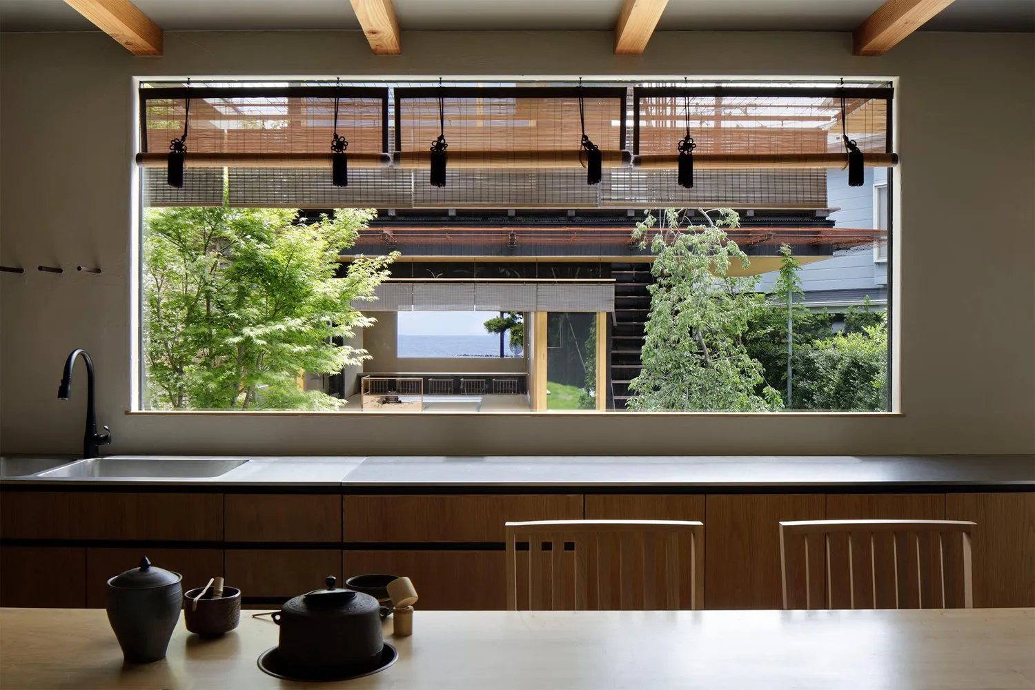 A contemporary kitchen with wooden cabinets and metallic accents.