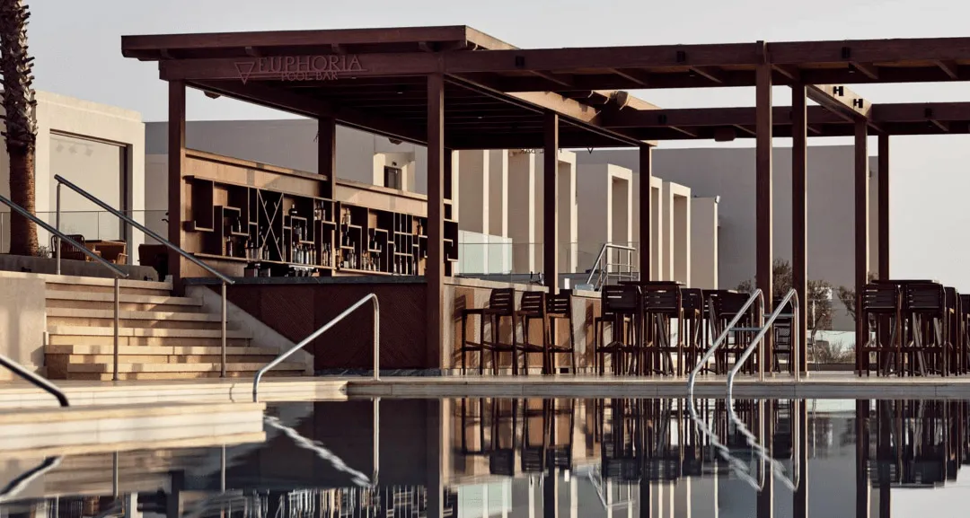 A modern architectural wooden pool bar featuring high stools and a bar counter.
