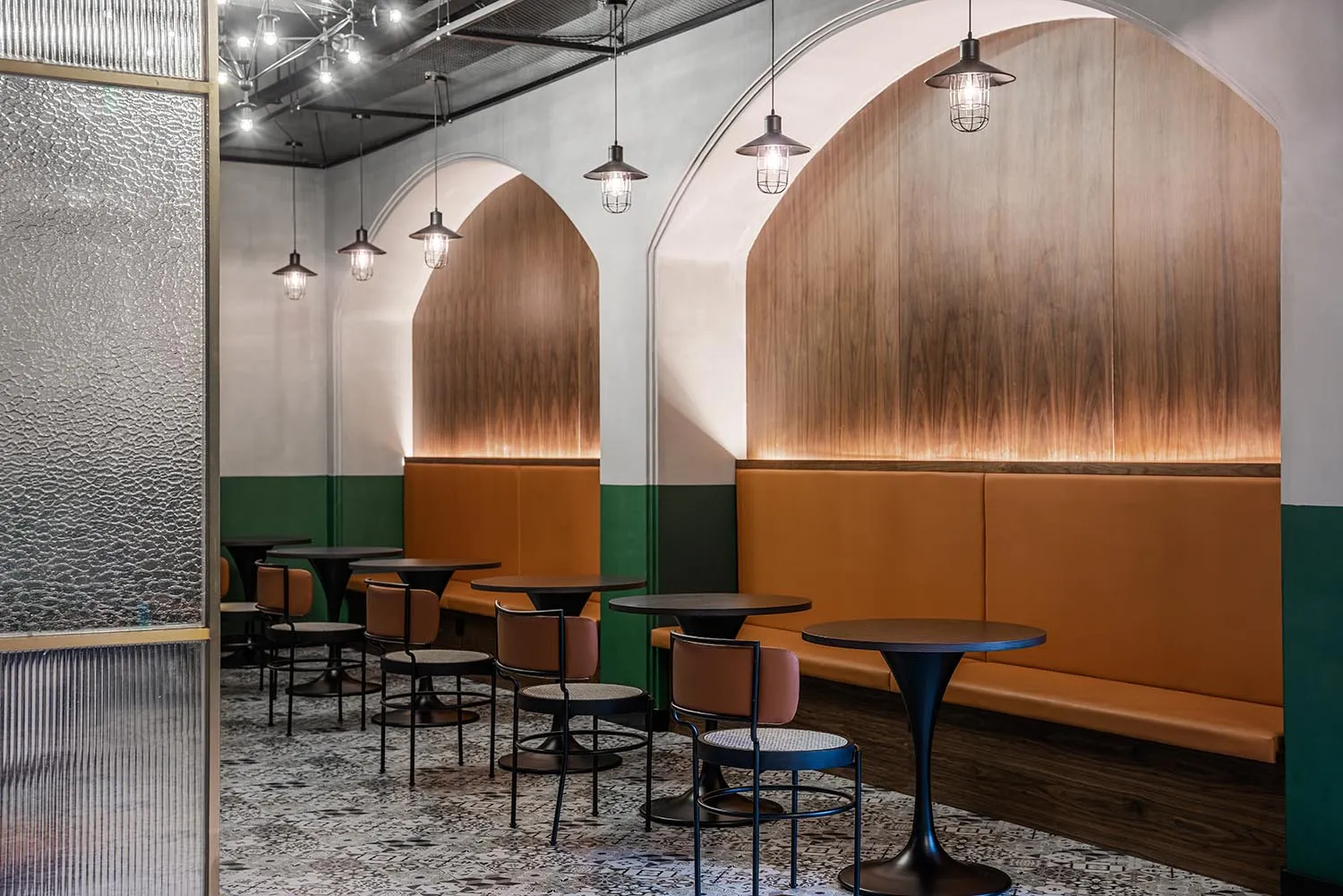 Modern cafe interior with booth seating featuring wooden accents and leather upholstery