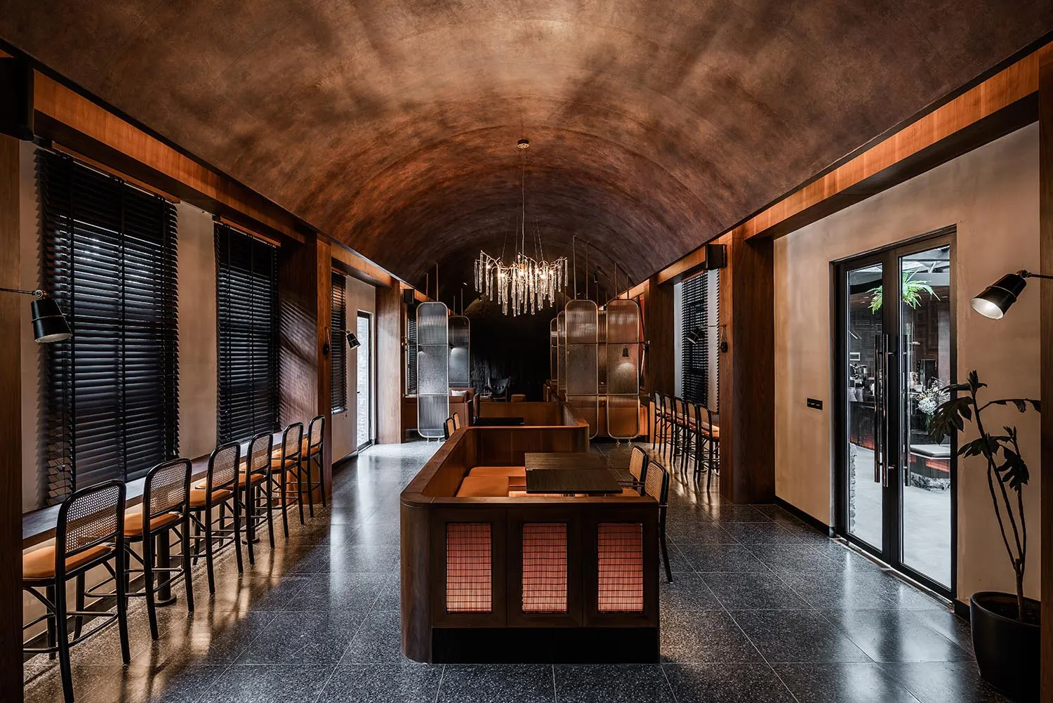 A modern cafe interior with metal, wood, and glass materials.