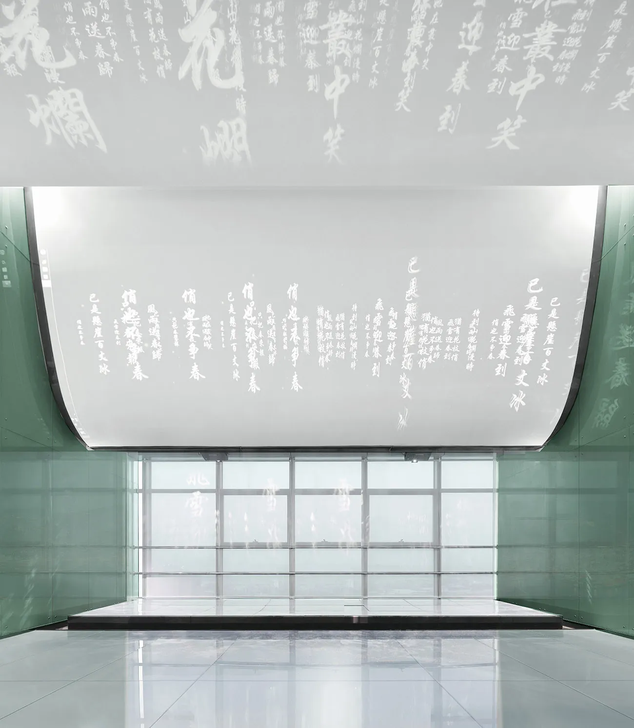 A modern lobby featuring glass walls and a minimalist design.