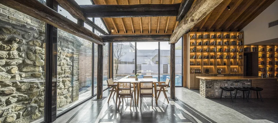Modern residential wine bar featuring concrete, wood, and brick materials with a contemporary design.