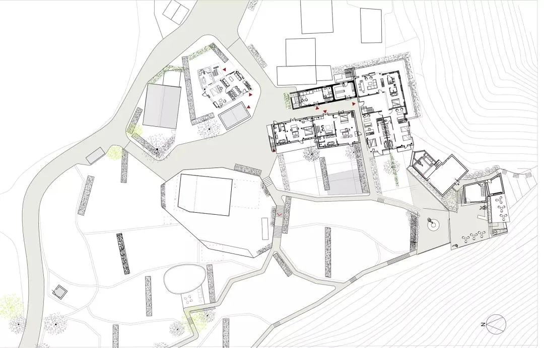Floor plan of a modern residential building with various rooms and outdoor spaces.