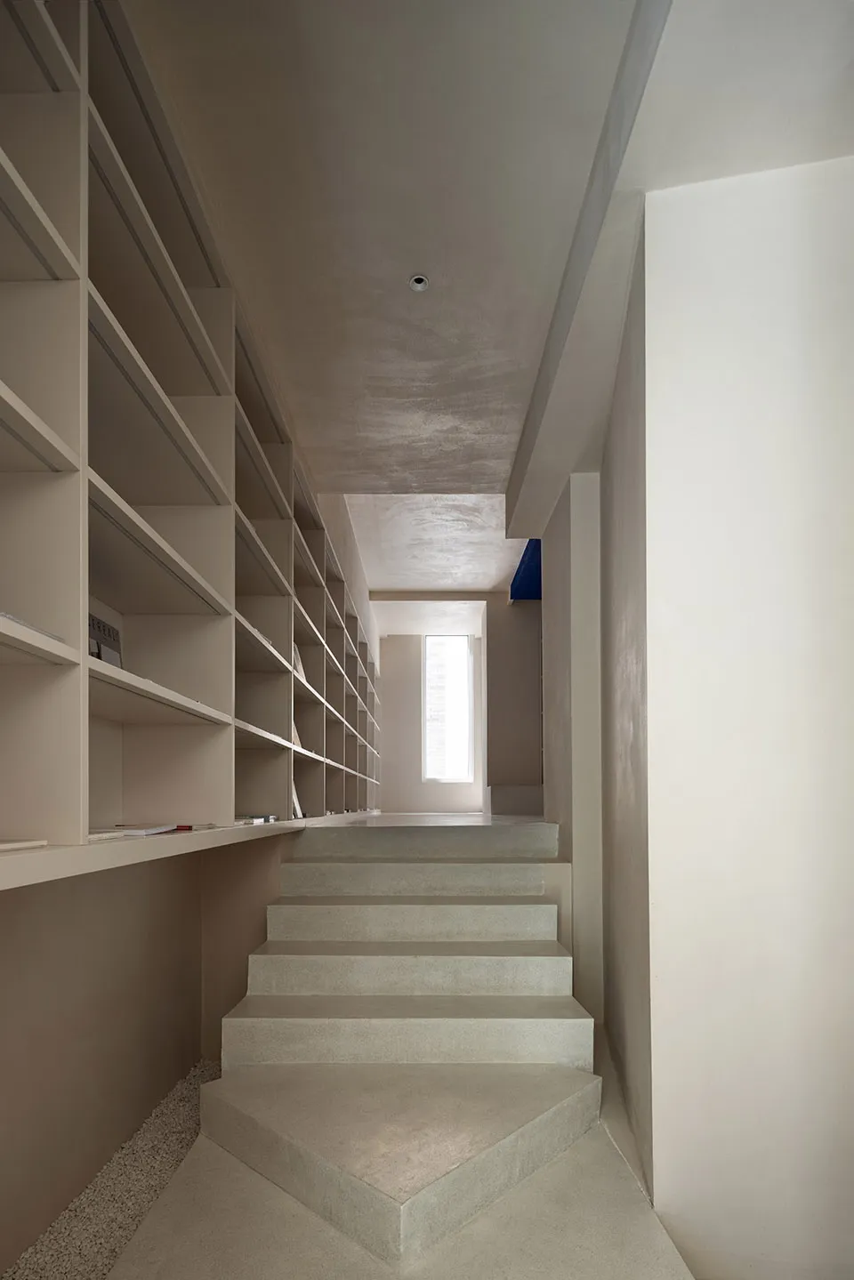 Modern concrete staircase interior with minimalistic design and natural lighting.