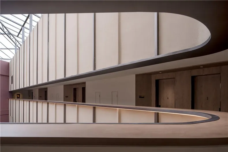 A modern corridor featuring wooden panels and doors.