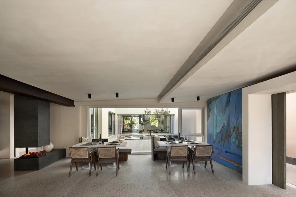 Modern dining room featuring a concrete floor, contemporary furniture, and large windows.
