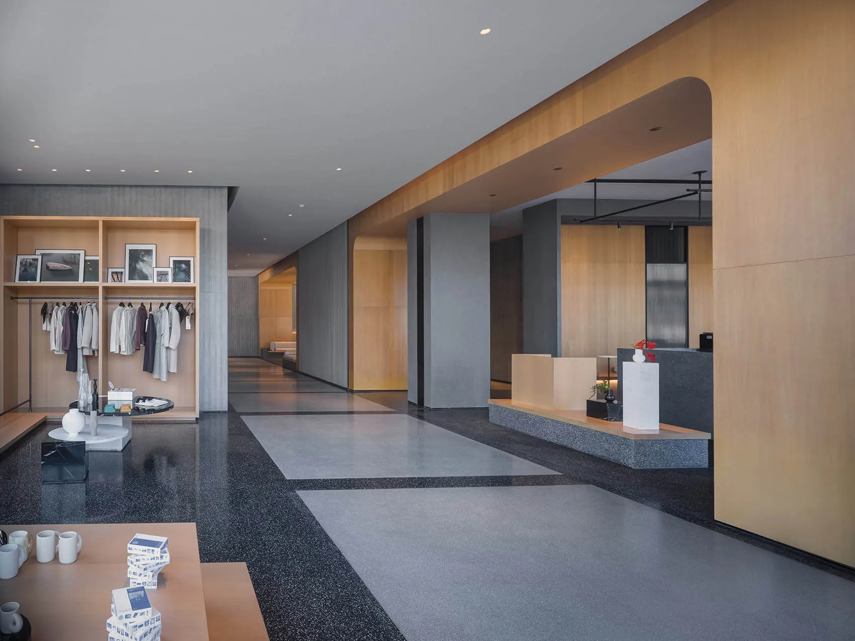 Modern hotel lobby featuring sleek concrete and wooden features.