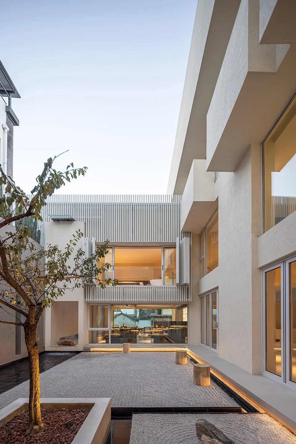 A modern residential interior featuring concrete and glass materials