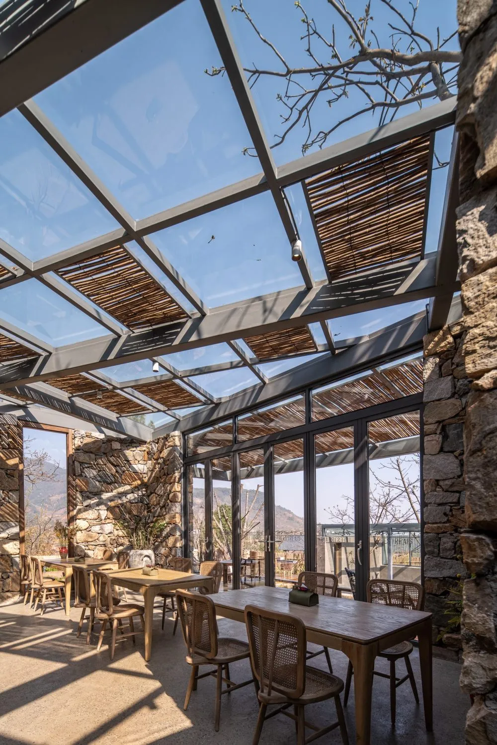 A cozy coffee shop with a glass rooftop and stone walls