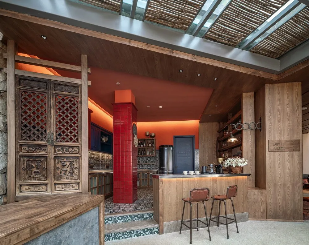 Modern industrial bar counter with wood-texture tiles and concrete flooring.