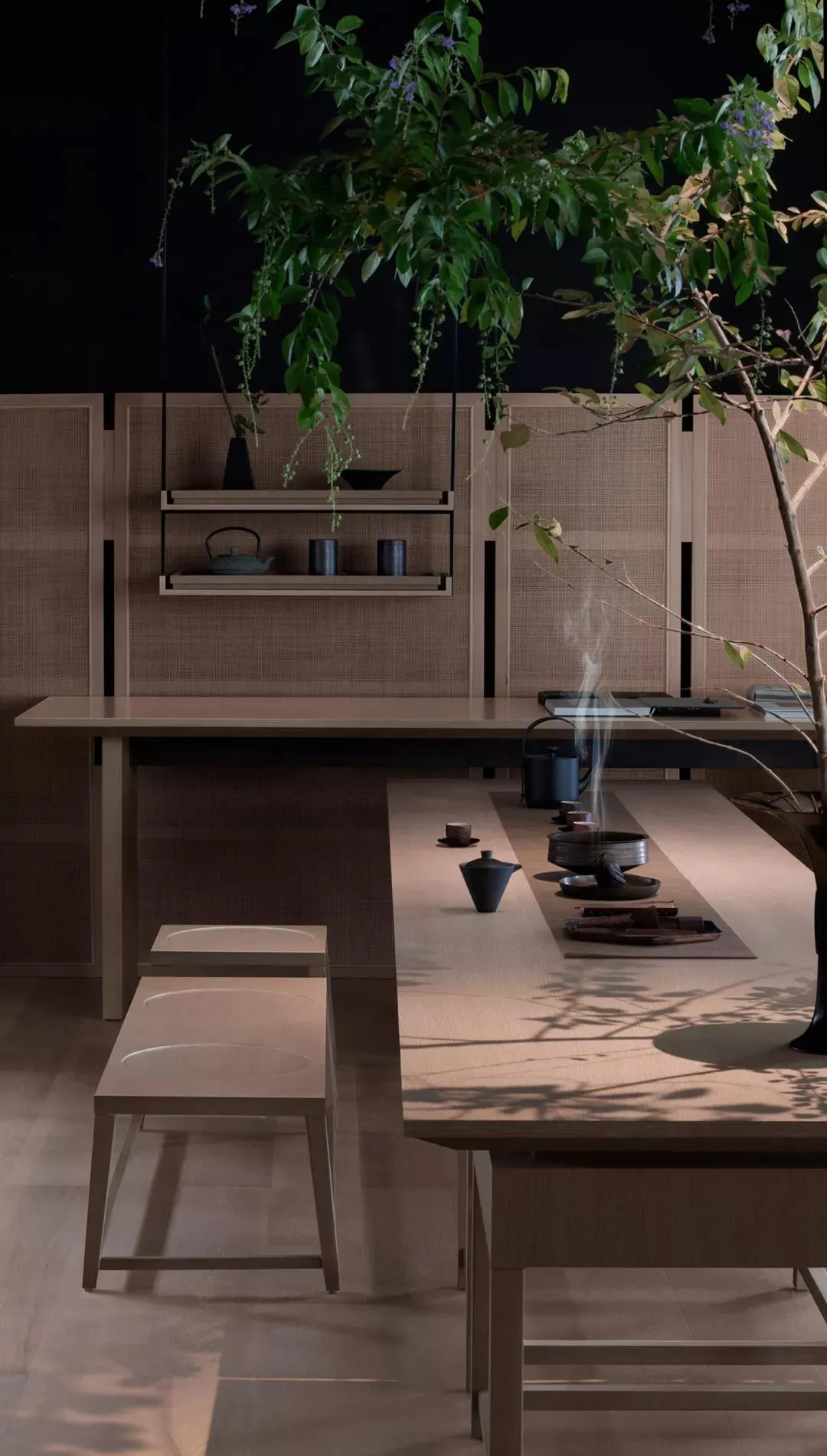 Modern, cozy tea ceremony space with wooden elements and greenery.