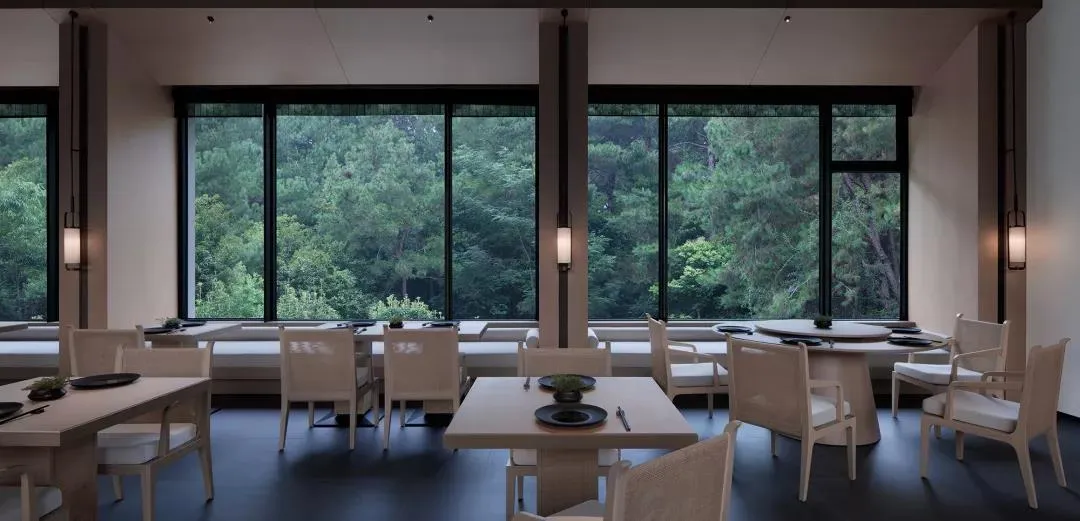 A restaurant interior featuring white wood furnishings, animal skin accents, and a marble counter.