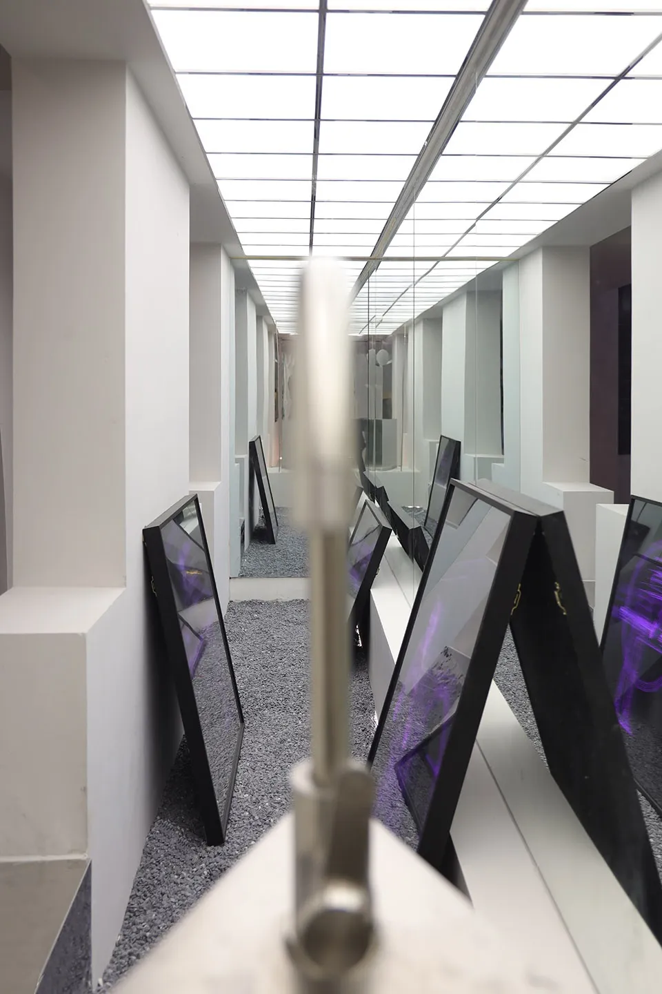 Installation artwork featuring geometric shapes with purple lighting.