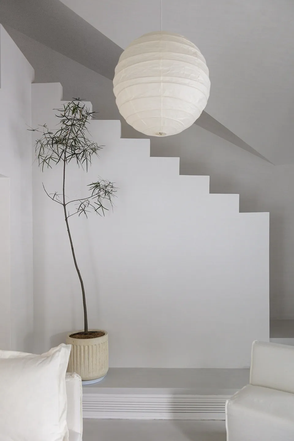A minimalist interior with white tiles and concrete walls
