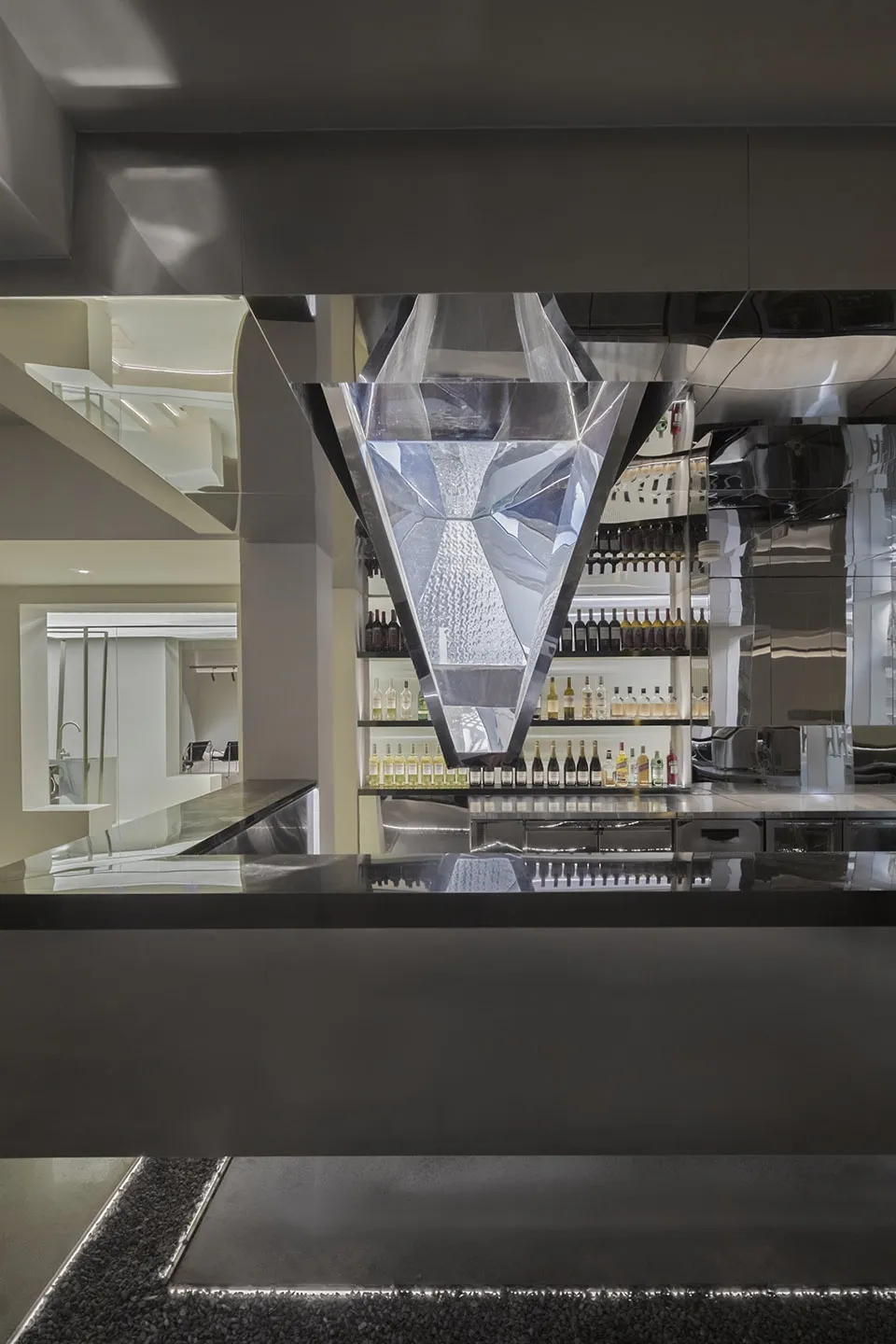 A modern bar with glass walls and reflections in a hospitality interior setting.