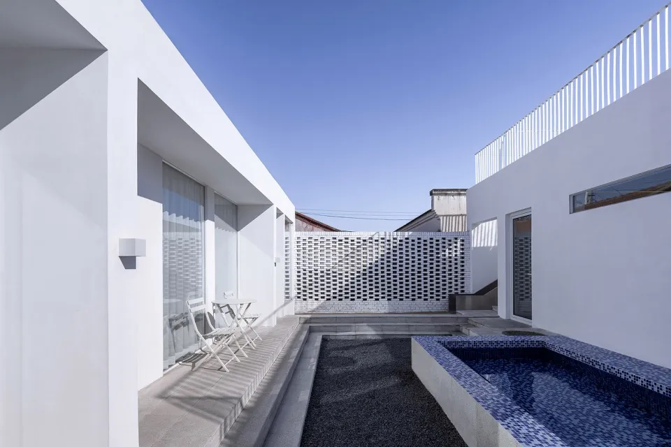 Modern house with concrete exterior and pool.